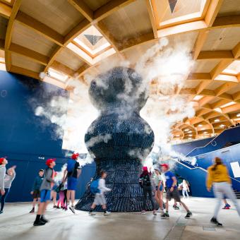 Kids running around Infinity Blue sculpture